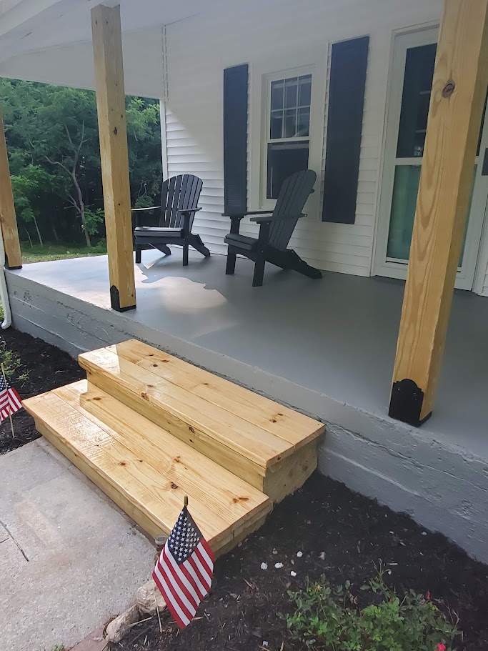 Exterior painting and porch renovation featuring white siding, dark shutters, and a gray painted porch floor.