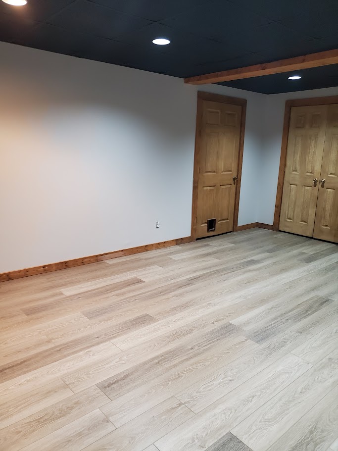 Decorative gray plaster wall finish surrounding a recessed linear fireplace with a smooth contemporary appearance.