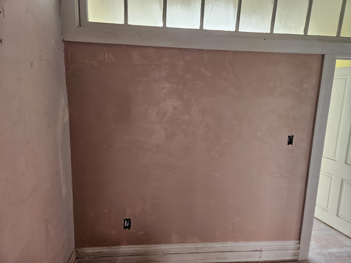 Rose-colored decorative Venetian plaster wall finish with subtle texture and a soft mottled appearance.